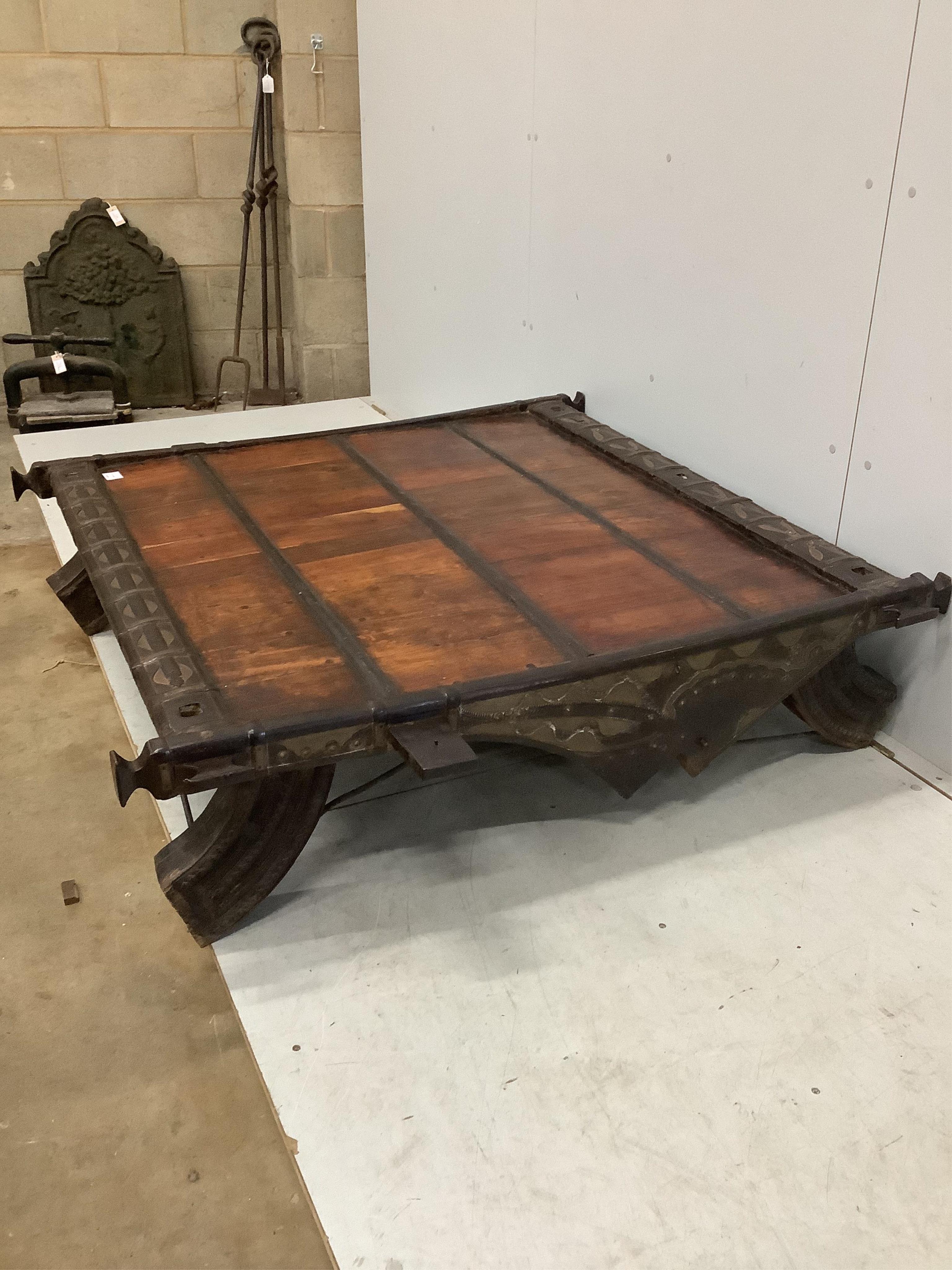 An Indian hardwood and iron mounted low square table, width 138cm, depth 130cm, height 33cm. Condition - fair